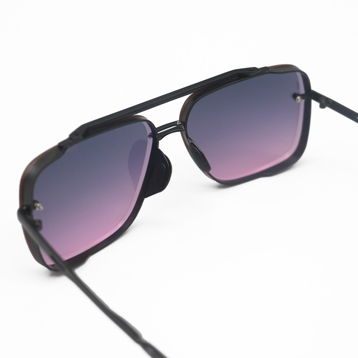 Bella Sunglasses are square aviators with faded purple to pink lenses and black metal details. Including tangle free technology.