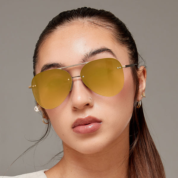 Model wearing classic aviators with no nosepad and mirrored gold lenses with metal detailing