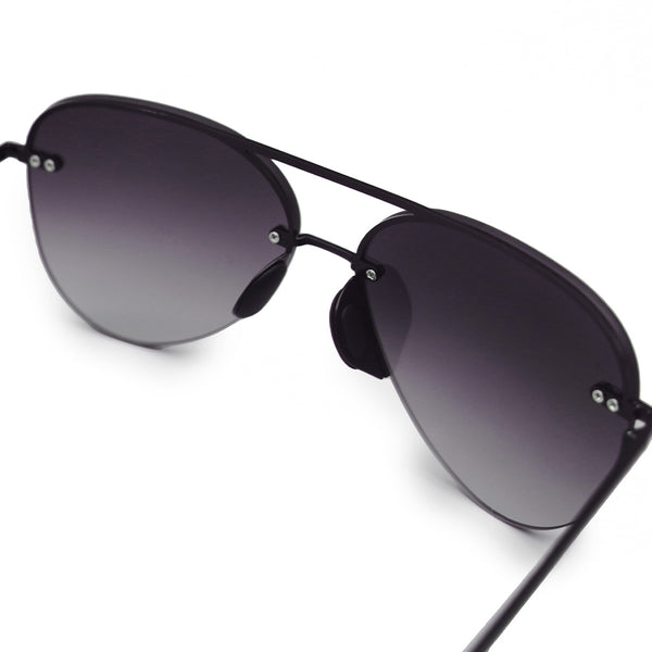 white background picture of classic Aviators with faded black lenses and metal detailing close up view