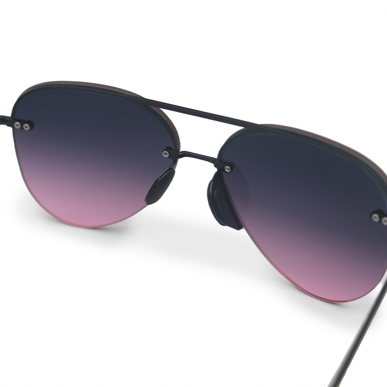White background close up image of classic aviators with no nosepad and faded purple pink lenses with metal detailing