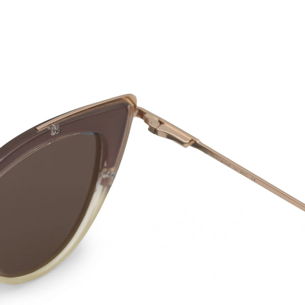 Close up view of white background picture of oversize faded brown glossy cateye sunglasses with metal detailing