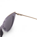 Close up of white background picture of oversize lavander glossy cateye sunglasses with metal detailing